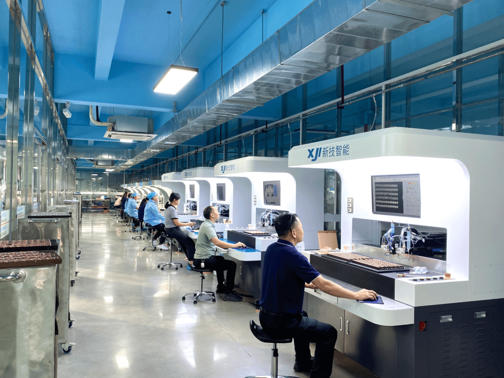 Workers monitoring automated coloring equipment to produce high-quality metal crafts.