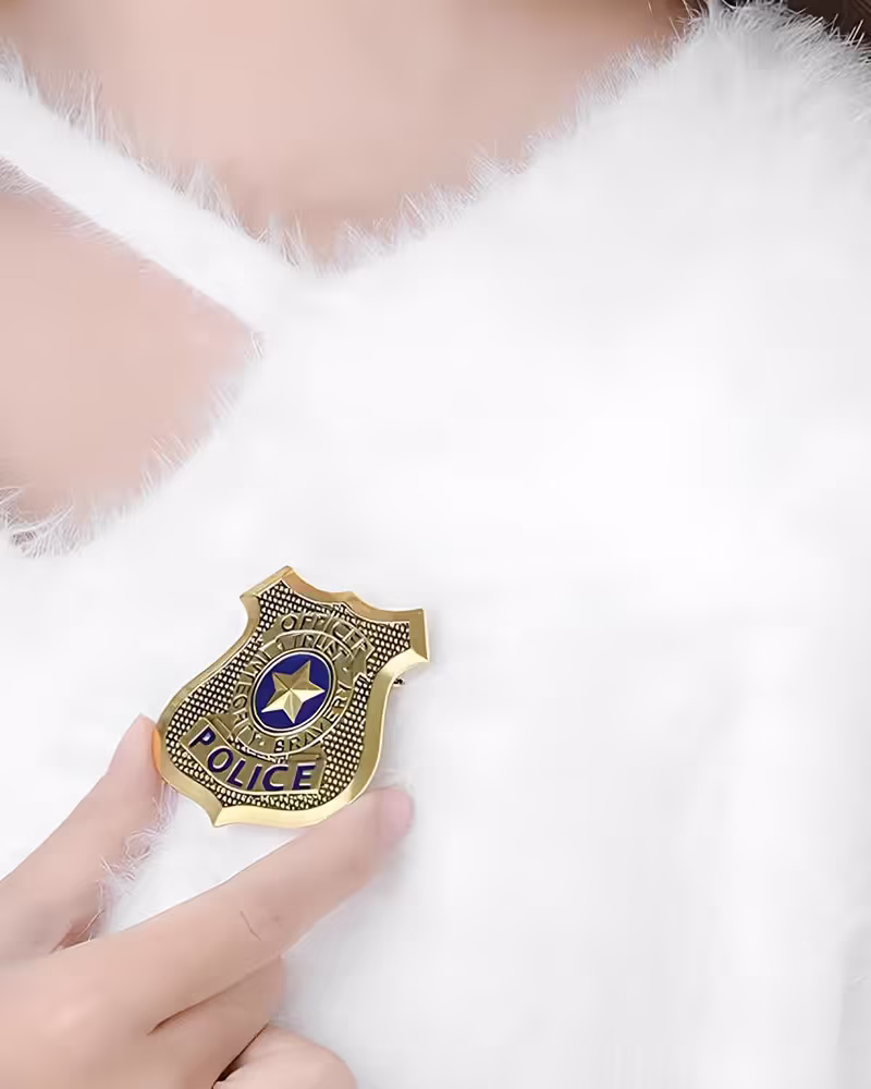 Classic enamel police badge lapel pin on uniform jacket