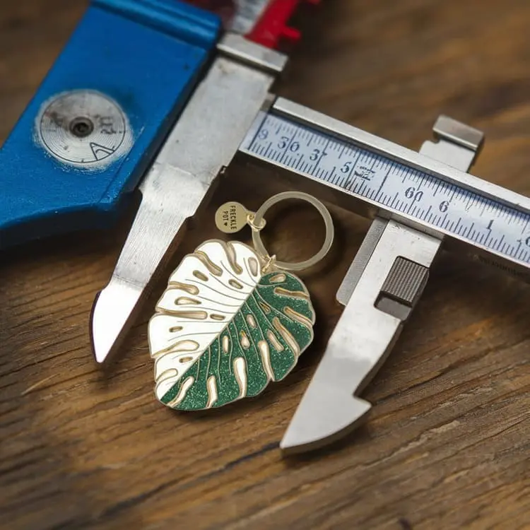 Quality control inspection of a custom keychain prototype, ensuring precision and finish